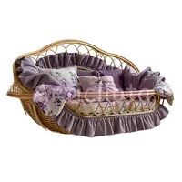 Wicker baby bassinet with ruffled purple bedding and floral pillows. Watercolor nursery furniture isolated PNG for baby shower invitations and planners.