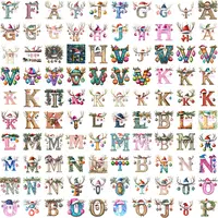 Watercolor Christmas Alphabet grid view featuring letters A-Z topped with reindeer antlers, festive hats, and colorful ornaments. Vibrant style perfect for sublimation designs and classroom decor.